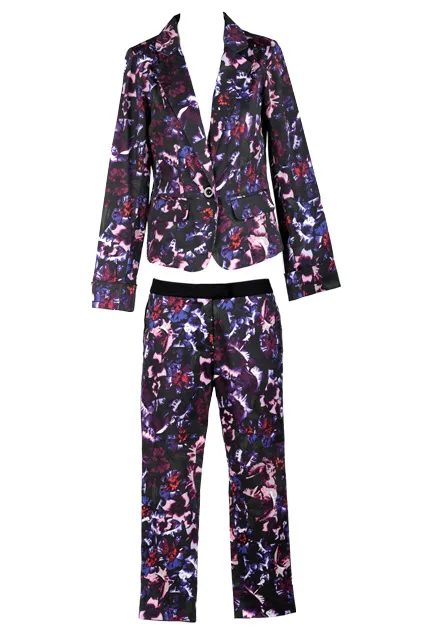 Floral-patterned women's pantsuit with dark base colors, featuring a blazer and matching trousers, on a white background.