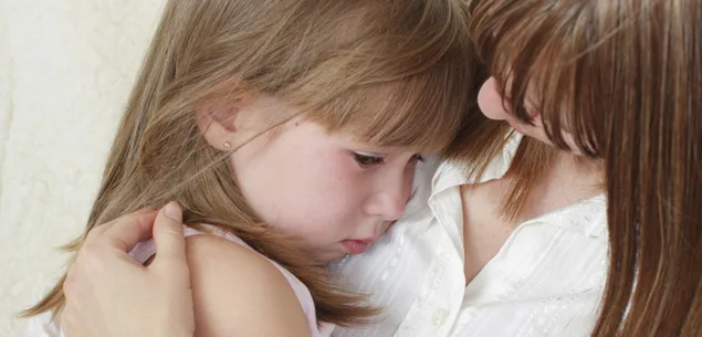 Mother consoling her crying daughter