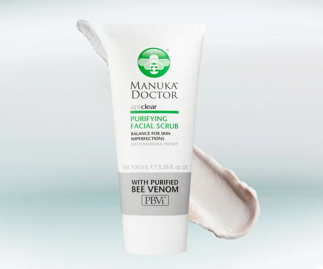 Manuka Doctor Purifying Facial Scrub tube with product smear, featuring bee venom and Manuka honey.