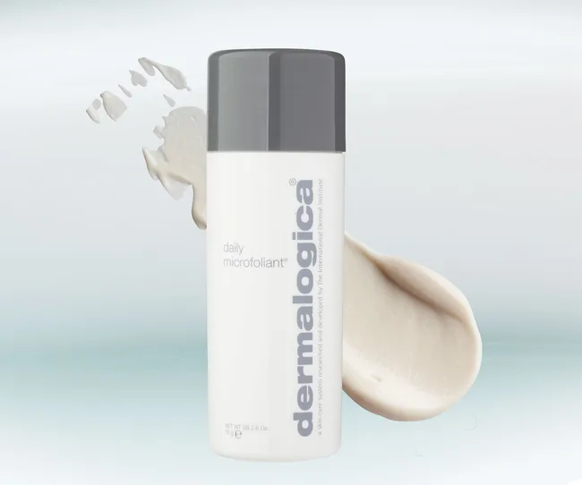 Dermalogica Daily Microfoliant bottle with exfoliating powder on a light blue background.
