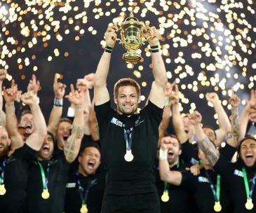 Richie McCaw holds up the Rugby World Cup trophy