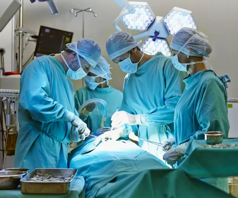 Surgeons operating on patient