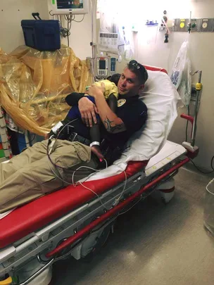 Policeman comforting sick kid