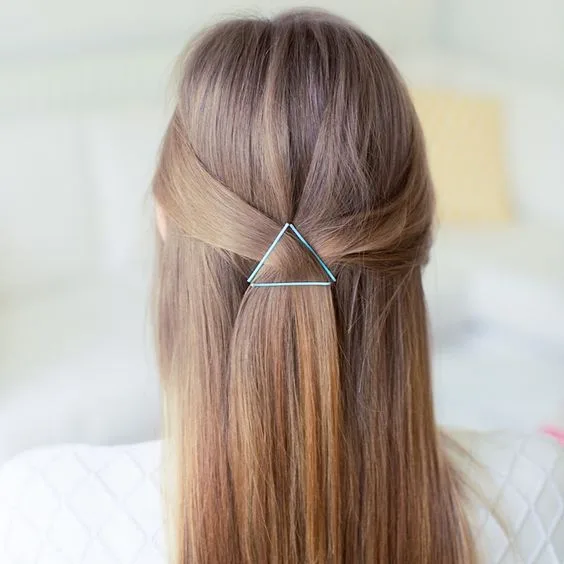 Brown hair styled with a triangle hairpin at the back.