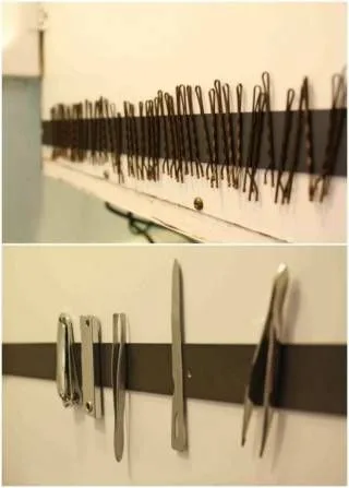 Magnetic strip holding many bobby pins on top and various metal grooming tools below on a wall.