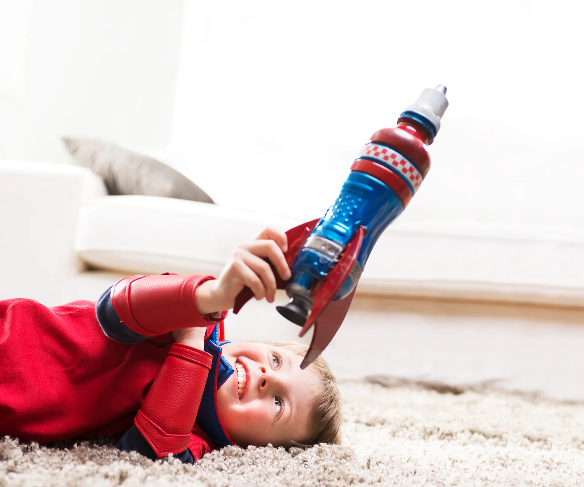 Boy holding rocket toy