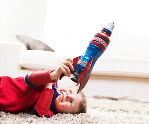 Boy holding rocket toy