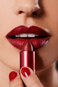 Woman applying lipstick
