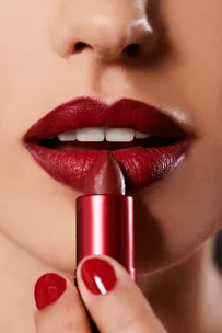 Woman applying lipstick
