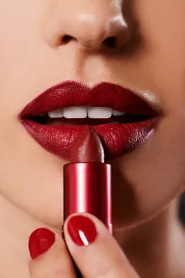 Woman applying lipstick