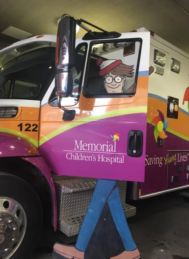 Cartoon character on a colorful ambulance at Memorial Children's Hospital entrance.