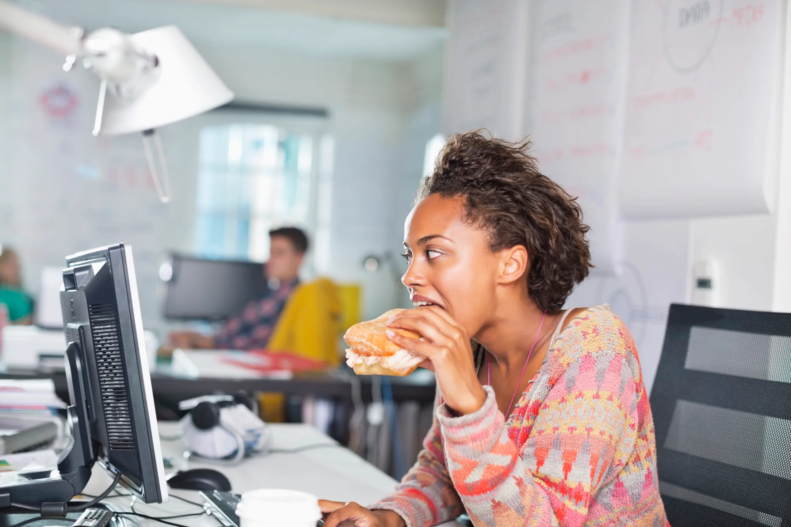 Woman eating lunch in her office
