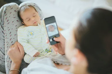 mum taking photo of baby