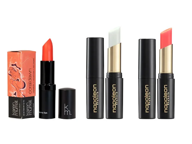 Lipsticks arranged side by side; orange, white, and pink shades, from Karen Murrell and Napoleon Perdis brands.