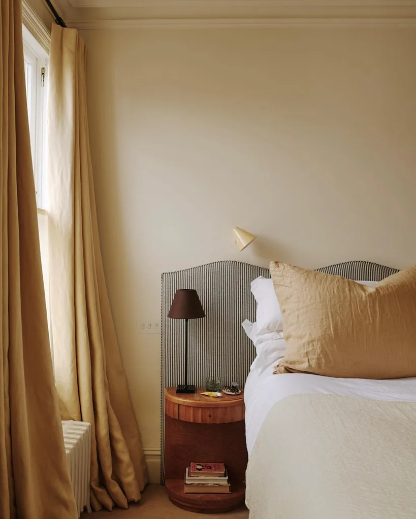 Butter yellow drapes that puddle on the floor in Lucy Williams bedroom