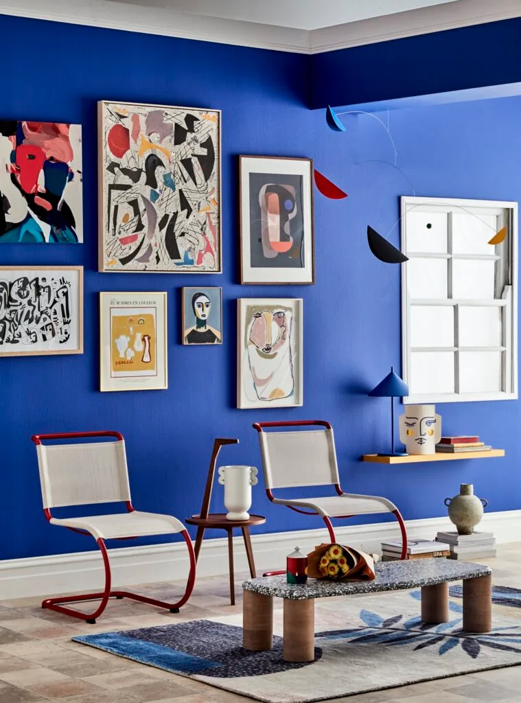 blue painted wall with gallery hang