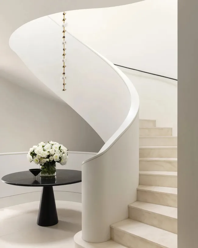 A selective palette based on Dulux Whisper White creates a soothing entrance to Paul Conrad&rsquo;s home. Viabizzuno &lsquo;Sempre Mia&rsquo; pendant from VBO Australia. Limestone floor tiles and Agapecasa &lsquo;M&rsquo; table in Nero Marquina from Artedomus