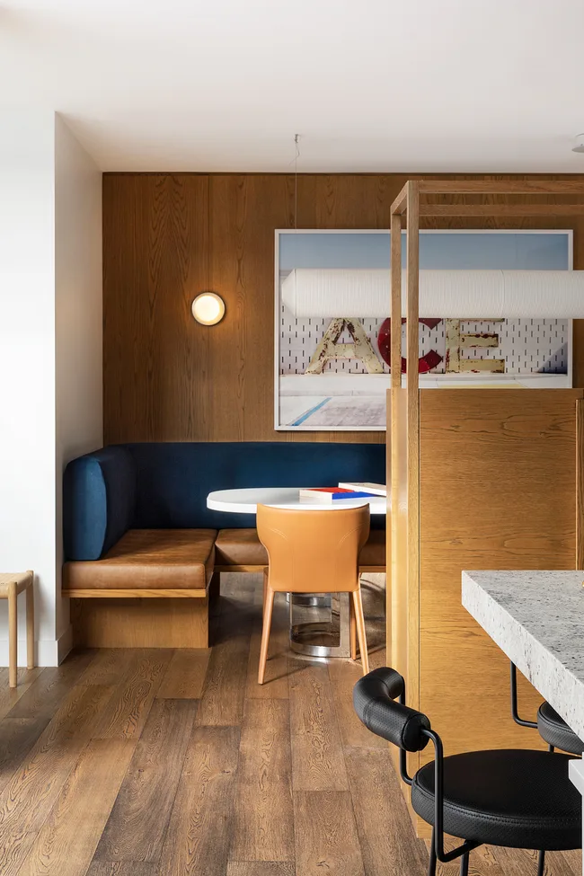 a mid-century-style banquette dining area with blue and timber tones