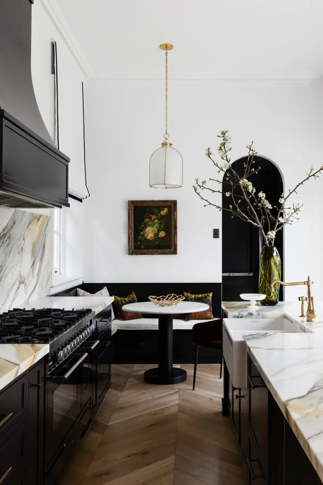 Modern monochromatic kitchen and dining area in Mosman