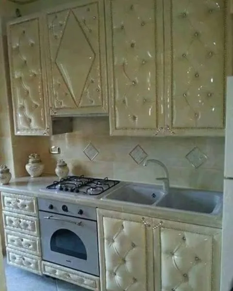 A kitchen with cream-coloured quilted cabinets