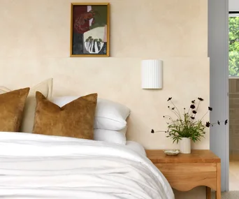 A neutral-toned bedroom with white bedding