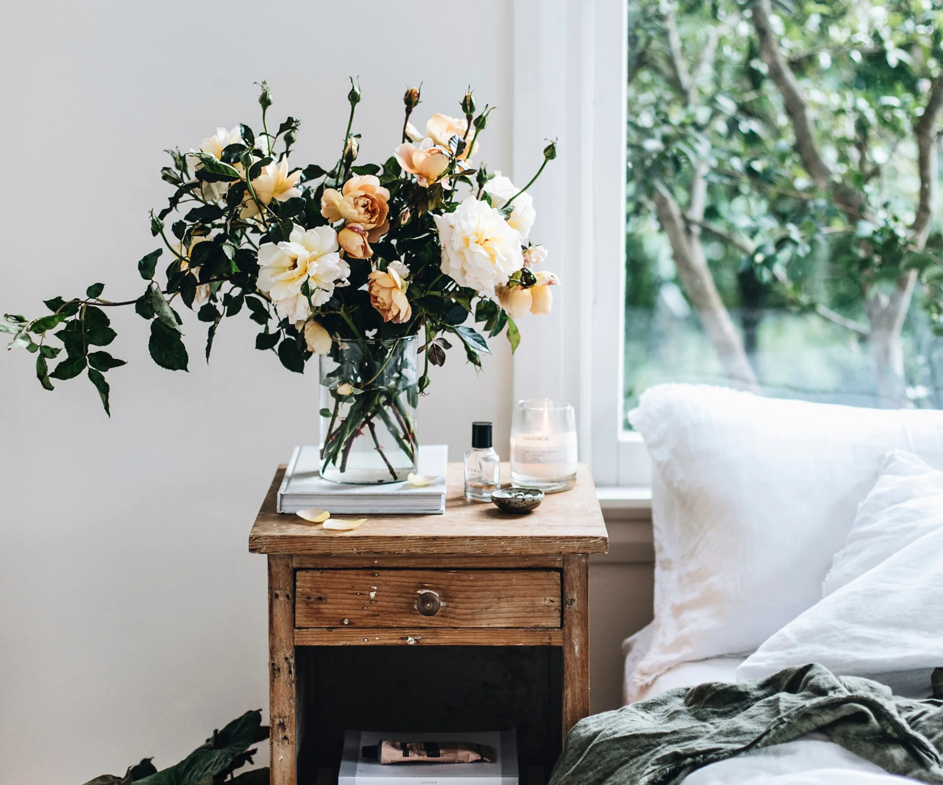 A bouquet of flowers on a bedside table