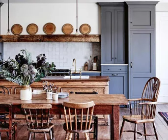 Country kitchen with dark grey cabinet and large dining table