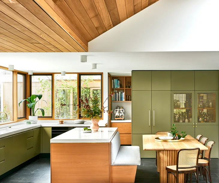 A mid-century-style kitchen with olive green cabinetry