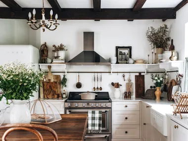 A rustic country-style kitchen with exposed timber beams