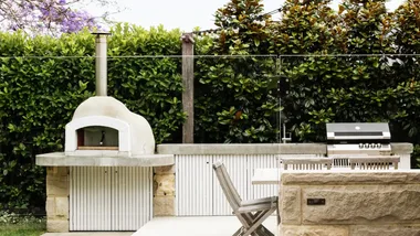 A backyard with a built-in barbecue