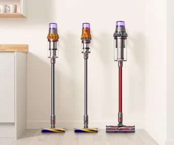 A row of three Dyson cordless vacuums