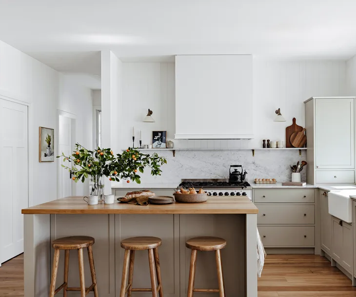 A contemporary country kitchen with a timber-top island bench