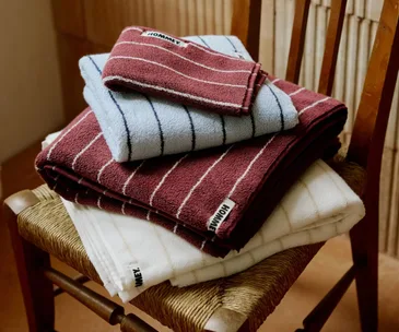 a stack of hommey towels on a chair