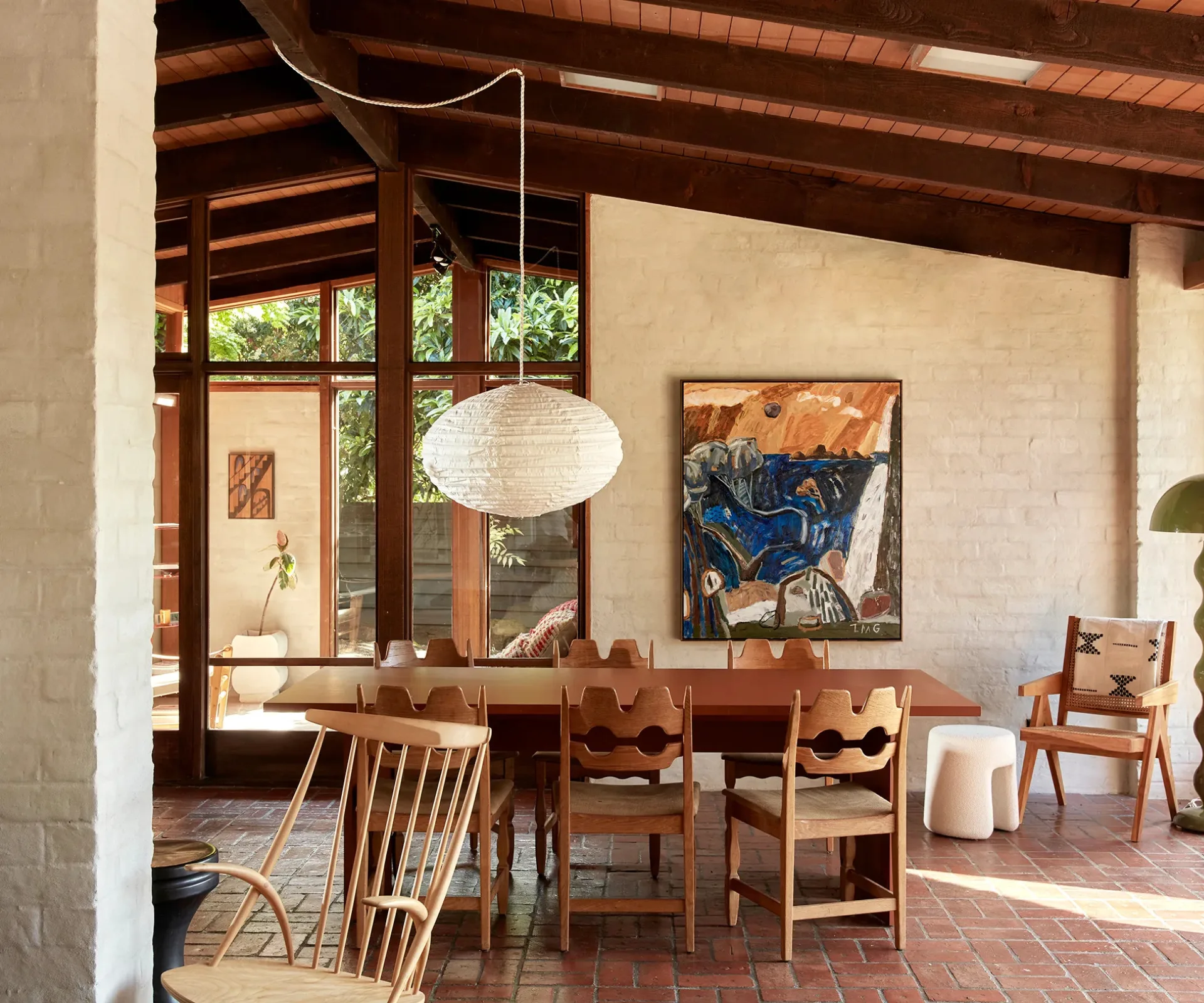 The open-plan dining area of a mid-century home decked out in timber