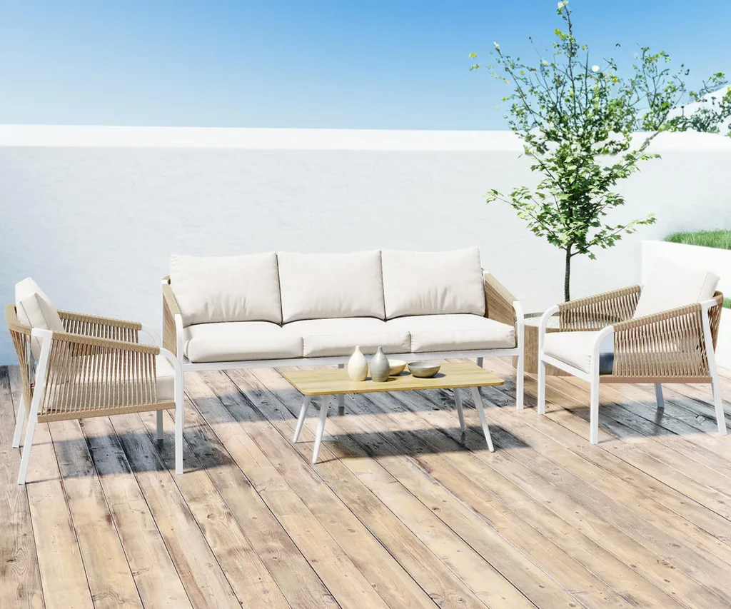 A wicker and white outdoor lounge set on a timber deck