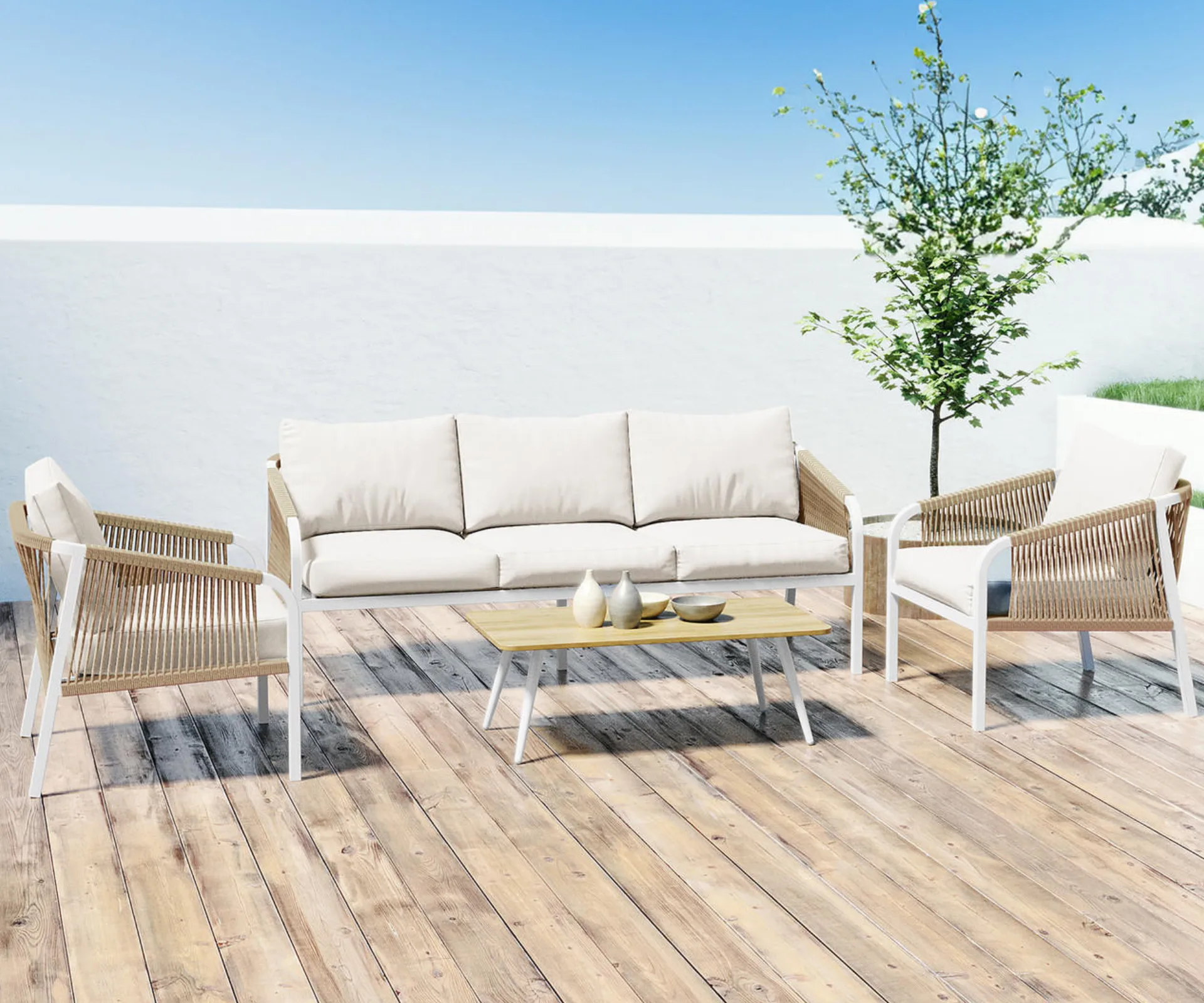 A wicker and white outdoor lounge set on a timber deck