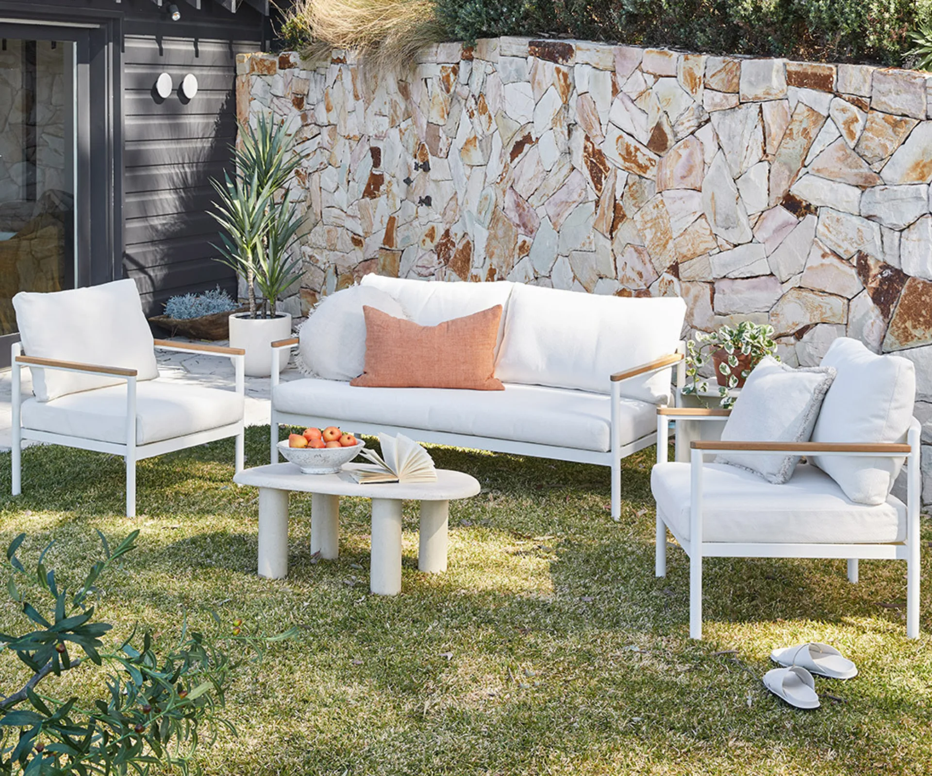 A white outdoor lounge set with cushions