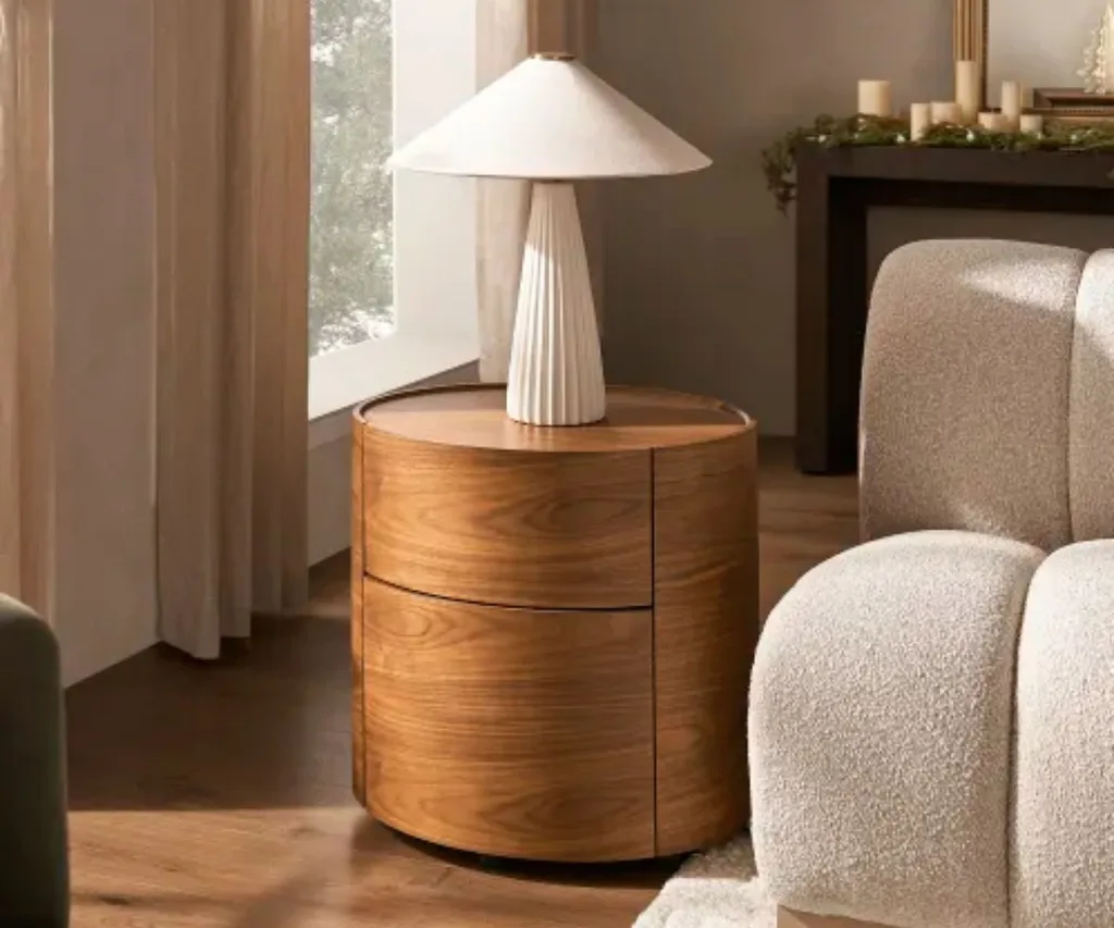 Curved wooden side table with white lamp