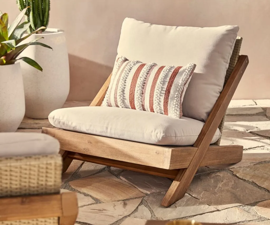 Outdoor armchair with cream cushions