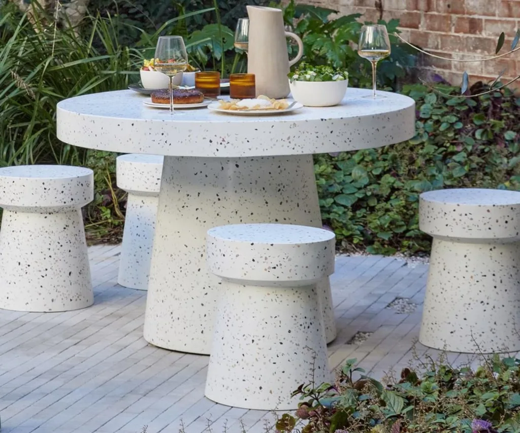 Terrazzo look outdoor dining table with four matching stools