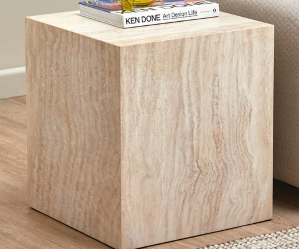 Travertine stone side table with book on top