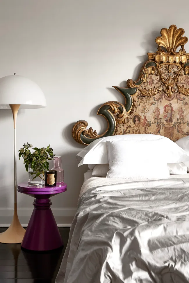 A bedroom with a baroque bedhead with Florentine handpainted details