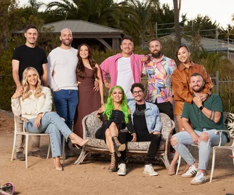 The cast of the 2024 season of The Block sitting in chairs on a sandy worksite