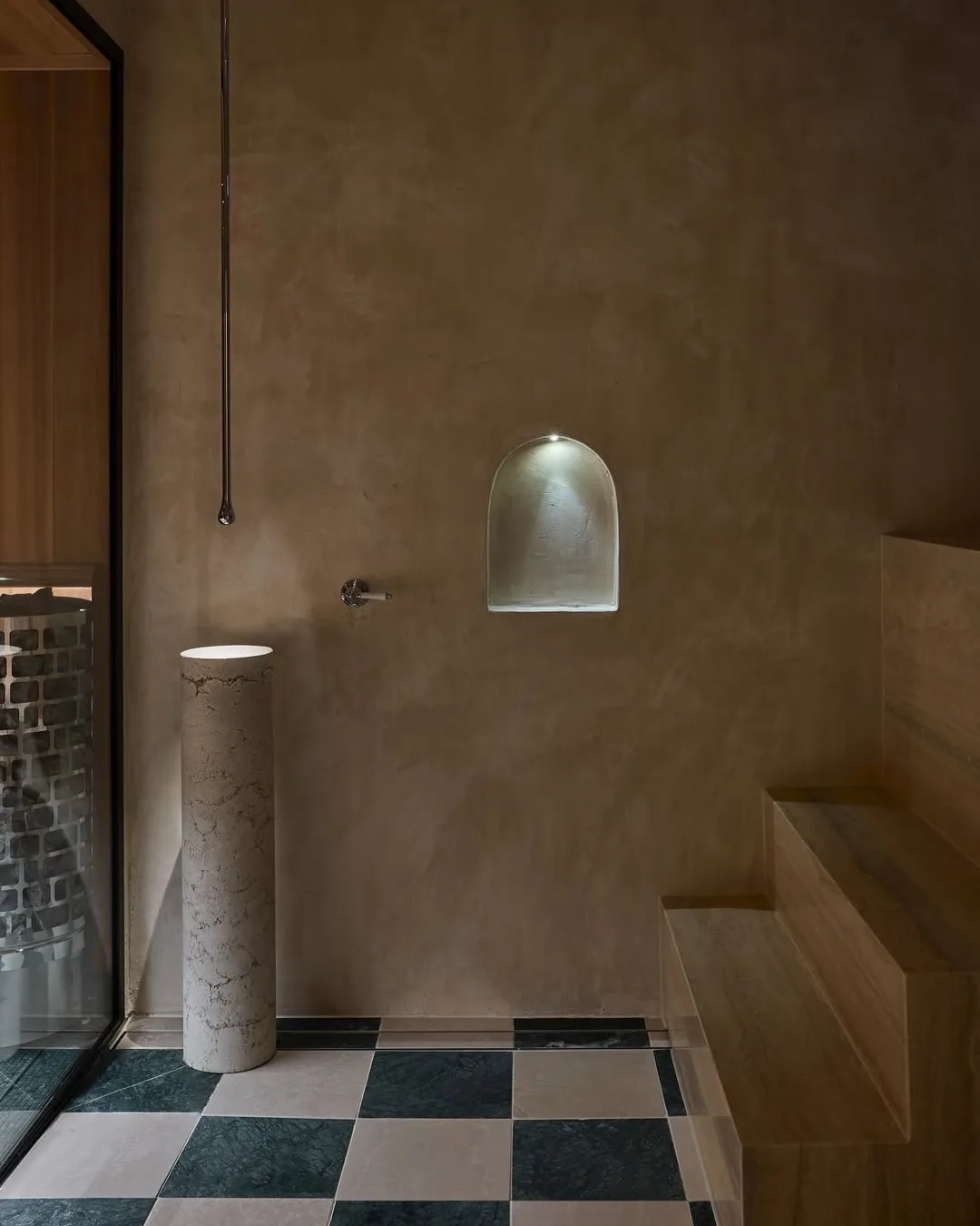 A brown rendered bathhouse with check floors