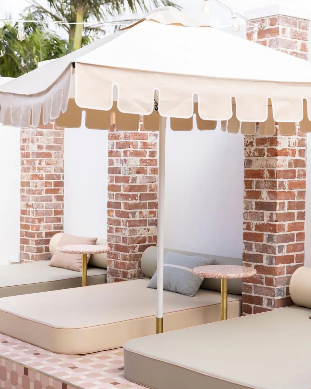 A brick-and-mortared patio with scallop umbrellas