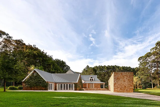 stone country home covered in vines