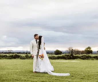 Lucy and Jack stood outside with the sunset in the background