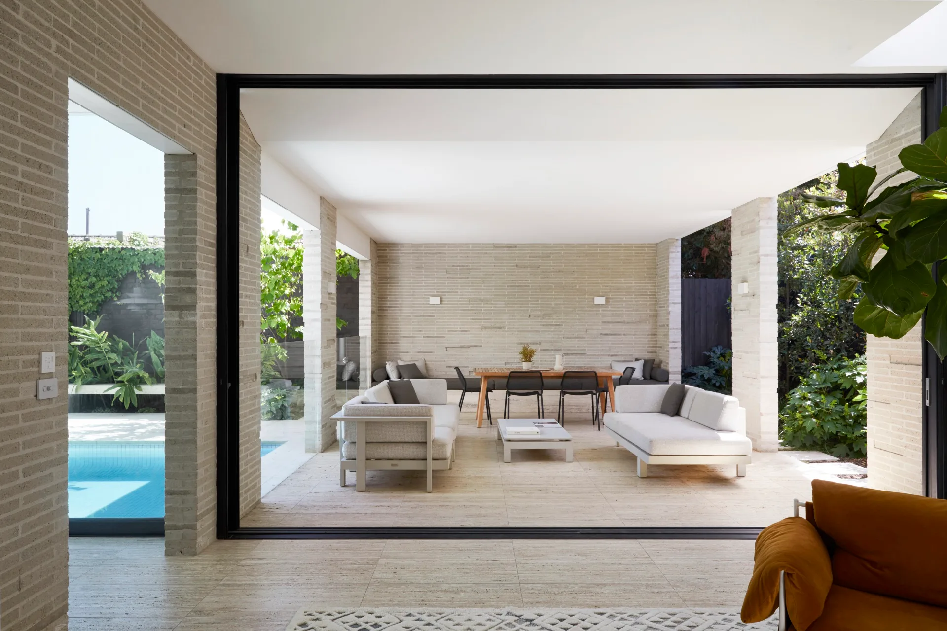 Alfresco area with an outdoor lounge and dining area beside a swimming pool