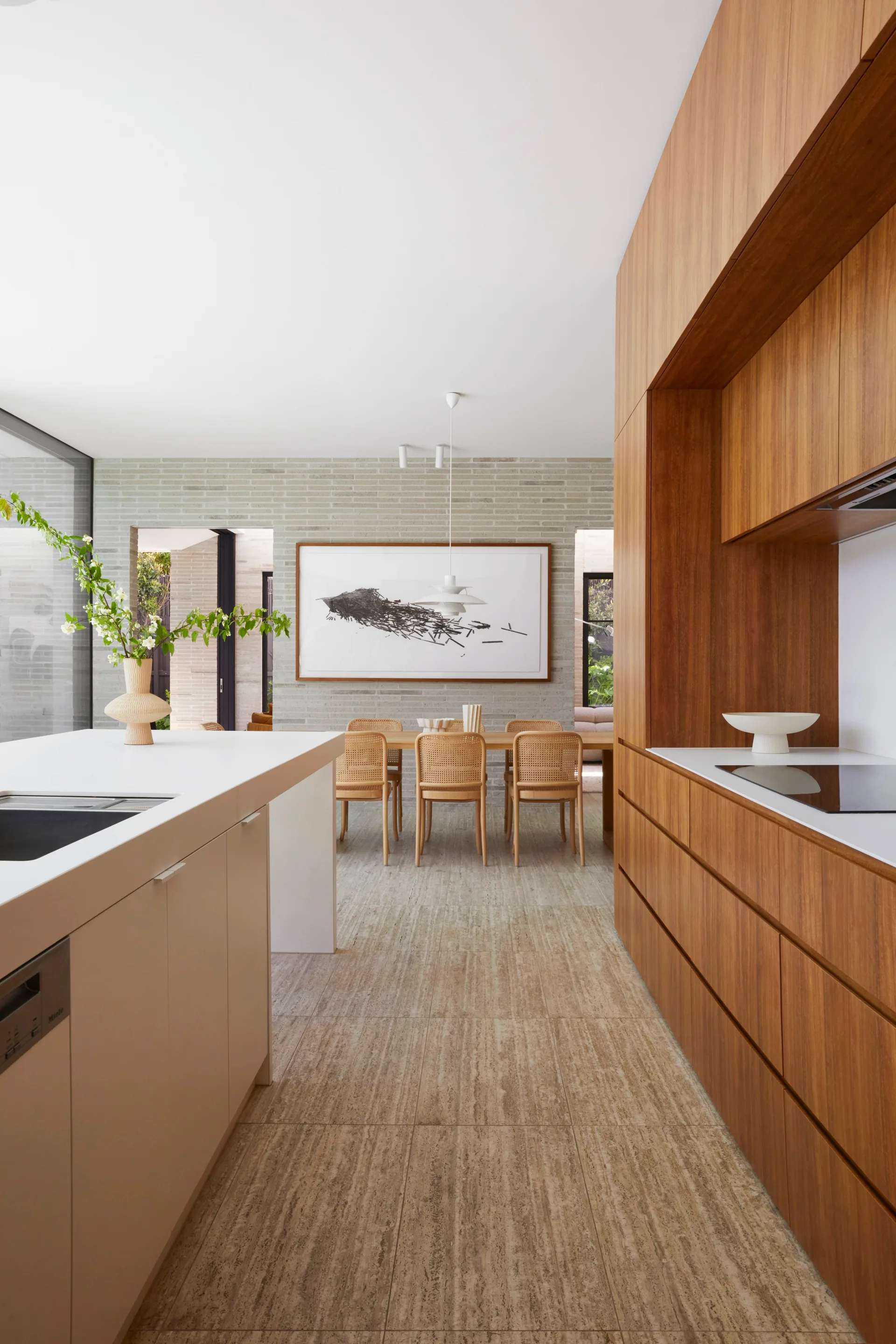 A timber kitchen and white island bench