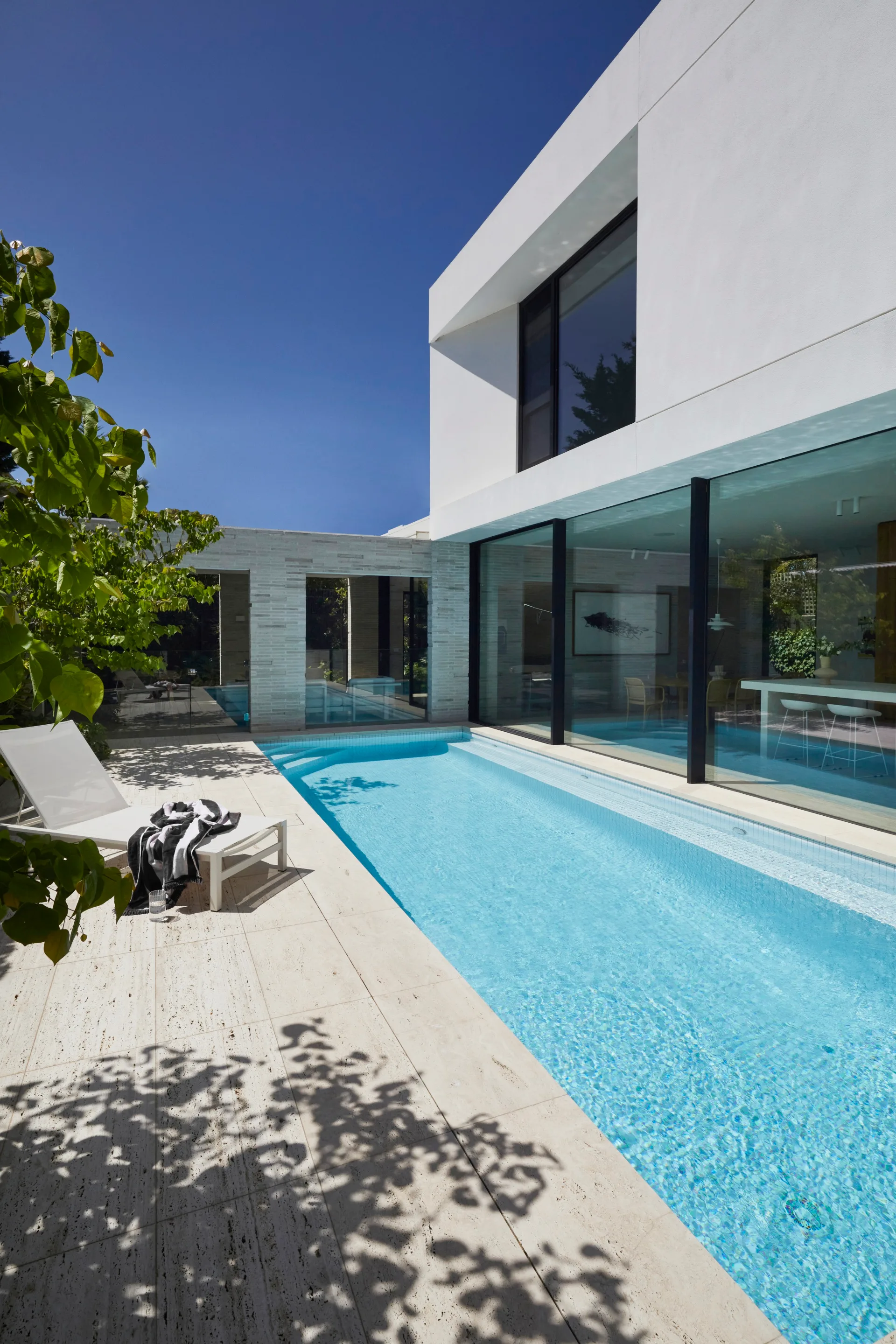Long swimming pool and a sunchair